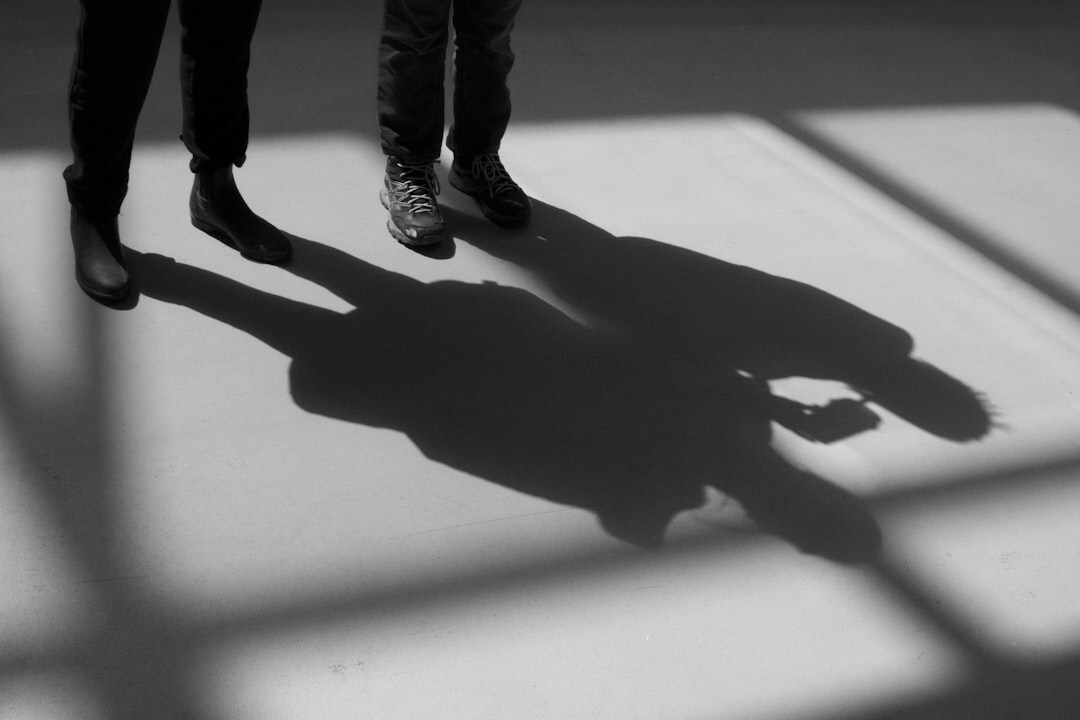 two people whispering in shadows